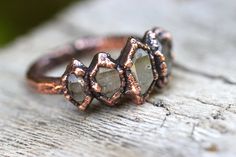 This quartz crystal ring is gorgeously organic and rustic. It features five double terminated Herkimer Diamond crystal points inside of copper. - Crystals measure 25mm by 11mm. - Each ring is made to order- crystals will vary slightly, but will be just as beautiful! - All items come gift wrapped, ready to give away or to treat yourself! Enjoy! Love electroformed crystals? Check out more here: https://www.etsy.com/shop/DeerGirlDesigns?section_id=14209058 Not sure of your ring size? Purchase one o Raw Crystal Engagement Rings Vintage, Engagement Ring Raw Crystal, Raw Crystal Engagement Rings Bohemian, Crystal Wedding Ring Raw, Bohemian Raw Stone Crystal Ring Gift, Crystal Engagement Rings, Double Terminated Crystal, Herkimer Diamond Ring, Raw Crystal Ring