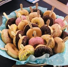 a bowl filled with lots of donuts on top of a table