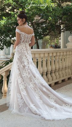 a woman in a wedding dress standing on a balcony