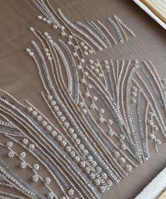 the beaded design is being worked on by an artisan in her home studio