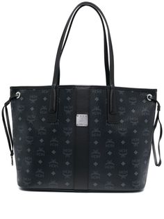 medium Liz reversible tote bag from MCM featuring black, canvas, coated finish, leather trim, monogram print, all-over graphic print, silver-tone logo plaque, reversible, circular top handles, open top, drawstring fastening and removable pouch. | MCM medium Liz reversible tote bag Black Mcm Bag, School Purse, Mcm Purse, Reversible Tote Bag, Goyard Bag, Mcm Bags, Girly Bags, Reversible Tote, Pretty Bags