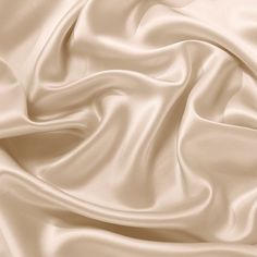 a close up view of a white satin fabric