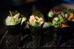 there are many different types of sushi on the trays with rice and lettuce