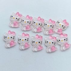 hello kitty buttons with pink and white bows on the ends are set against a white background