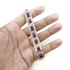 A stylish retro inspired ruby and diamond platinum bracelet. Set with Burmese cushion cut rubies 14.11 ct total. Accented by marquise and round cut white natural diamonds 6.83 ct total in floral border motifs. Diamonds are all natural in G-H Color Clarity VS. A gorgeous vintage Art Deco inspired bracelet. Length: 17.4 cm Width. 1.3 cm Weight: 46 g [shortcode] [video] [/video] [/shortcode] Border Motifs, Diamond Chandelier, White Gold Hoop Earrings, Platinum Bracelet, White Gold Hoops, Platinum Earrings, 18k Gold Jewelry, Deco Jewelry, Floral Border