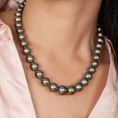 This one-of-a-kind necklace is composed of round, AA+ quality Tahitian pearls measuring 10.0-10.5 mm in diameter and approximately 18 inches in length including the clasp. The medium green strand has peacock overtones, sharp luster, exhibits some natural markings, and the pearls are arranged to complement their individual beauty. Your strand will arrive double-knotted on color-matching silk. The knots protect your pearls from rubbing against each other, and if your necklace ever breaks, you won' Peacock Green, Pearl Types, Tahitian Pearls, Gold Polish, Pearl Color, Black Pearl, Pricing Jewelry, Matte Gold, Color Matching