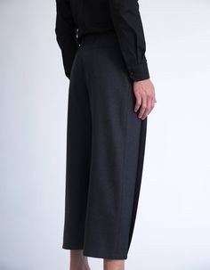 These tailored pleated pants are architectural, geometrical and crisp, yet at the same they are dynamic, full of volume and have a mesmerising movement. Pleating has been a key element in our latest collections, and all of our pleated items are treated and pleated individually. These pleated pants have front pleats that are closed at the hem, and are cropped above the ankle [full length and color options are available in the customisation section bellow]. Tailored from a soft polyester fabric, t Elegant Gray Wide-leg Dress Pants, Modern Tailored Wide Leg Pants With Pressed Crease, Elegant Gray Wide Leg Pants For Business Casual, Formal Gray Wide-leg Pants, Gray Wide Leg Business Pants, Gray Wide Leg Business Bottoms, Chic Gray Wide Leg Pants For Formal Occasions, Formal Gray Wide Leg Pants, Elegant Gray Ankle-length Wide Leg Pants