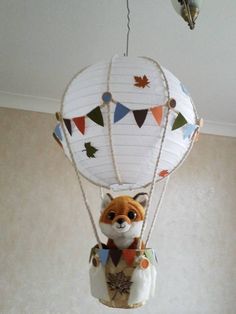 a stuffed animal in a hot air balloon