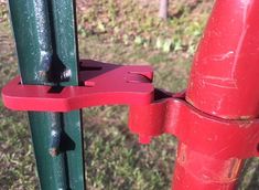 a close up of a red handle on a green pole