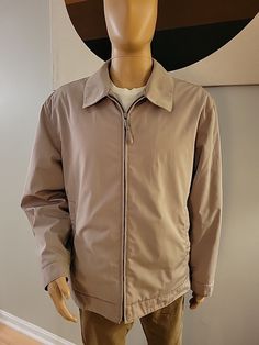 Claiborne PolyTech Mens Beige Lined Zip Soft Short Jacket Size XL. This is a really nice classic look for a light jacket. Quality Claiborne materials. Zip front with two hand pockets on both the exterior and interior. Button closure cuffs. As a size reference, mannequin is 6-feet tall and slender. Please see pictures for measurements and feel free to ask any questions you may have. The only blemish I could find is shown in last picture.  A small spot on the collar. Classic Windbreaker For Outdoor, Classic Outdoor Windbreaker, Classic Long Sleeve Windbreaker, Classic Collared Windbreaker For Winter, Classic Collared Winter Windbreaker, Soft Shorts, Short Jacket, Light Jacket, Classic Looks