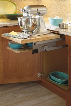 a stand mixer sitting on top of a wooden counter