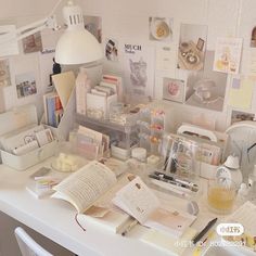 the desk is cluttered with books, papers and knick - knacks