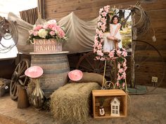 an old fashioned photo frame with pink flowers on it and other items surrounding it in front of a wooden wall