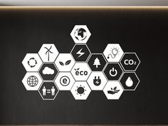 a black wall with white hexagons and symbols painted on it in an office