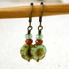 "This listing is for these vintage style, glass beaded, dangle earrings. They are wonderful mint green flower beads, orange brown, and a pale aqua with a touch of green. They are part of my coral pink and mint series. All the items from this series can mix and match. These earrings are 1.5 inches in length. They are light weight and comfortable. The smaller bead is 3 x 5mm in size, the Hibiscus flower bead is 12mm. This is available in a vintage look with antique brass (as shown), hypoallergenic Handmade Vintage Beaded Earrings With Round Beads, Retro Beaded Dangle Jewelry, Vintage Handmade Beaded Earrings, Nickel-free Vintage Drop Beaded Earrings, Vintage Nickel-free Drop Beaded Earrings, Vintage Green Nickel-free Flower Earrings, Vintage Beaded Earrings With Dangling Round Beads, Vintage Beaded Earrings As Gift, Handmade Czech Glass Flower Earrings In Vintage Style