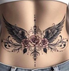 a woman's stomach with roses and wings on it