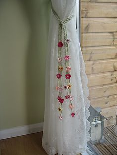 four different pictures of flowers hanging from the side of a window