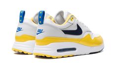 The Nike Air Max 1 '86 OG Golf "Solheim" is a colorway of the alternate golf version of the retro running shoe inspired by the European golf championship.  From a collection inspired by the USA’s Ryder’s Cup and Europe’s Solheim Cup, the Air Max 1 ‘86 OG Golf offers something for golf and sneaker fans alike.  Here, the “Solheim” version features a white leather base with grey leather overlays.  An Obsidian-colored leather Swoosh appears on the sides.  “Golf” detailing can be found on the heel while “Nike” branding is seen on the tongue.  The blue nylon pull tabs on the heel are contrasted with a yellow star motif.  A shiny yellow mudguard completes the look.  Release date: September 28, 2023 Golf Championship, Air Max One, Retro Running Shoes, Nike Branding, Ryder Cup, Star Motif, Yellow Star, Nike Trainers, Nike Brand