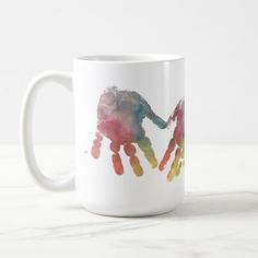 a coffee mug with an image of a handprinted elephant on the inside of it