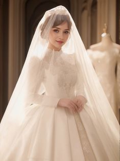 a woman in a white wedding dress and veil standing next to mannequins