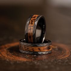 two wedding bands with wood inlays on them