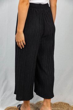 Looking for pants that can do it all? Slip into style with our Hadley Crinkle Pleated Wide Leg Pants! Made from unique crinkle fabric, these solid black pants offer a comfy yet dressy look that you can also rock casually. The elastic waistband and wide leg design make them super comfortable and versatile. We love them with a bodysuit, a tucked-in top, or a slouchy sweater. They’re even perfect over swimwear or on top of a romper. The Hadley pants are your go-to for effortless style, no matter th Pleated Black Wide Leg Pants For Summer, Black Pleated Wide Leg Pants For Summer, Casual Black Pleated Wide Leg Pants, Casual Black Wide Leg Pleated Pants, Black Relaxed Fit Pleated Bottoms, Black Casual Pleated Pants, Casual Black Pleated Pants, Pleated Wide Leg Pants, Crinkle Fabric