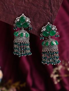 Introducing our exquisite Dark Green Statement Jhumkas with Stone Work - a dazzling fusion of tradition and contemporary elegance. These high-quality earrings are meticulously crafted to add a touch of glamour to any outfit, making them the perfect accessory for special occasions or everyday wear. Crafted with precision and attention to detail, these jhumkas are not just stunning but also exceptionally lightweight. You can enjoy the glamour of statement earrings without compromising on comfort. The lightweight design makes them perfect for extended wear, allowing you to dance the night away or confidently carry them throughout your daily activities. Whether you're attending a wedding, a festive celebration, or simply looking to elevate your style, these Dark Green Statement Jhumkas with St Festive Fusion Chandelier Earrings With Stone Work, Festive Fusion Chandelier Earrings, Fusion Style Tilla Jhumkas Drop Earrings, Green Dangle Jhumkas For Festive Occasions, Fusion Style Dangle Jhumkas, Fusion Style Festive Jhumkas With Stone Work, Heavy Fusion Style Festive Chandelier Earrings, Heavy Fusion Chandelier Earrings For Festive Occasions, Festive Fusion Jhumkas With Stone Work