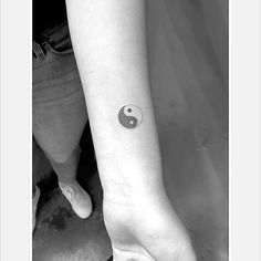 a woman's arm with a small tattoo on the left side of her wrist