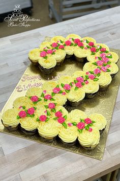 a cake shaped like the number five with roses on it sitting on top of a table