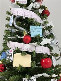 a christmas tree decorated with medical notes and ornaments