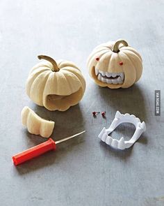 pumpkins with teeth and dental instruments on a table next to each other, including a toothbrush