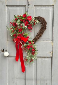 a heart shaped wreath hanging on the front door