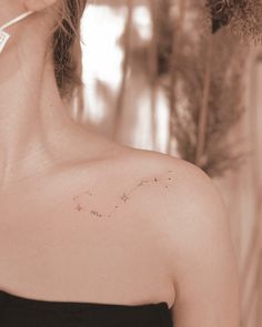 a woman with a star tattoo on her left shoulder