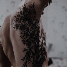 the back of a man with tattoos on his body