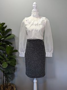 **Made in Canada** This high waisted, mixed gray, Joseph Ribkoff skirt is the epitome of stylish comfort. The stretchy material hugs your curves, while allowing plenty of movement. An ideal piece to wear for work and going out! Excellent condition, no stains or damage. Tag says size 8, stretch likely allows for modern US women's size 6-10 or S-M. Please remember to take your measurements. Vintage sizing may vary greatly! Waist: 26" (elastic) Hips: 36" Length: 23" Sweep/Hem: 36" Gray High Waist Skirt For Work, Gray Pencil Skirt Bottoms For Office, Elegant Gray Mini Skirt For Work, Elegant Gray Pencil Skirt For Workwear, Gray Lined Skirt For Work, Elegant High Waist Gray Skirt, Fitted Fall Pencil Skirt For Office, Gray Pencil Skirt For Workwear, Gray Pencil Skirt For Work