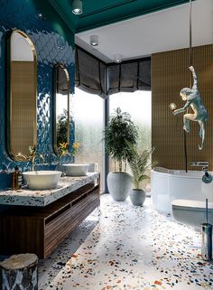 a bathroom with two sinks, a tub and a large mirror on the wall above it