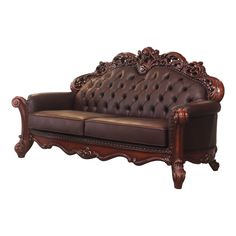 a brown leather couch sitting on top of a wooden frame with carvings and wood trimmings