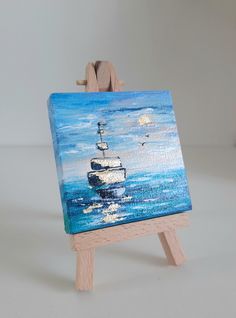 a small easel with a painting on it