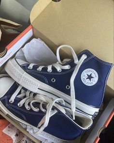 a pair of blue and white sneakers in a box