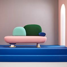 a colorful couch sitting on top of a blue platform