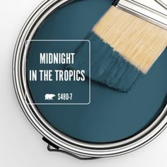 a paint can with the words midnight in the tropics on it and a brush