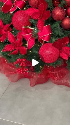 a christmas tree decorated with red ornaments and poinsettis