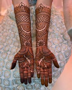 two hands with henna designs on them