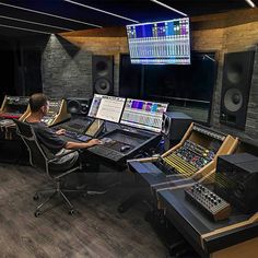 a man sitting in front of sound mixing equipment