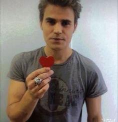 a man holding a heart shaped object in his hand