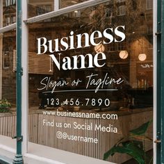 a business sign is in the window of a storefront that says, business name