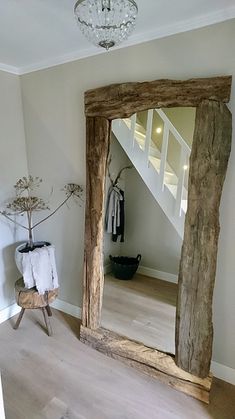 a large mirror sitting on top of a wooden floor