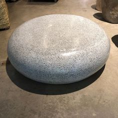 a large stone sitting on top of a cement floor