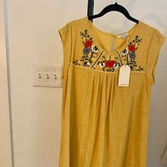 Cute Linen Yellow Dress With Beautiful Embroidered Flowers. Hits Above The Knee And Is Lined! Never Worn, New With Tags. Size Small. Casual Embroidered Summer Dress, Casual Embroidered Dress With Floral Print, Casual Floral Embroidered Dress For Day Out, Yellow Bohemian Embroidered Short Sleeve Dress, Yellow Cotton Knee-length Dress, Yellow Embroidered Folk Dress, Yellow Semi-stitched Embroidered Fabric With Embroidered Border, Above The Knee, Embroidered Flowers