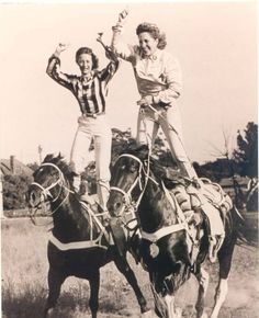 two women riding on the back of horses in an old black and white photo,